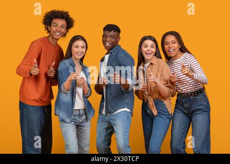 Thumbs up from a multiethnic young team Stock Photo