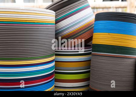 Multi-colored plastic plant containers stacked tightly in rows to form an abstract display of color and texture. Stock Photo