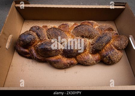 Large loaf of freshly baked, braided challah or egg bread for sale at a bakery in Jerusalem on the eve of the Jewish sabbath. Stock Photo