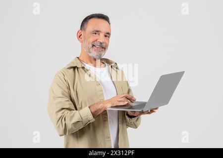 Man Holding Laptop Computer On White Background Stock Photo