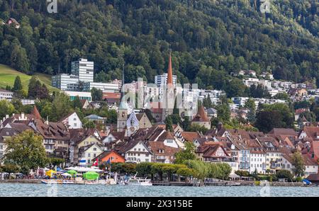 Blick über den Zugersee auf die Zuger Altstadt mit den Kirchtürmen und den alten Häusern. (Zug, Schweiz, 10.09.2022) Stock Photo