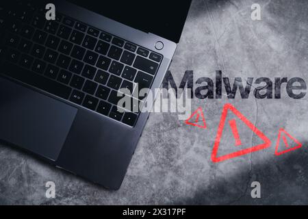 Top view photo of laptop on desk with malware alert. Compromised information concept. Internet virus cyber security and cybercrime. Stock Photo