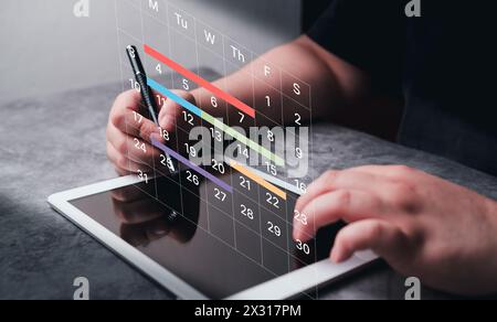 Woman use digital tablet to mark dates on virtual hologram calendar. Businesswoman managing her business schedule. Setting reminders and appointments Stock Photo