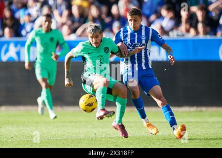 Angel Correa of Atletico de Madrid compete for the ball with Nahuel Tenaglia of Deportivo Alaves during the LaLiga EA Sports match between Deportivo A Stock Photo