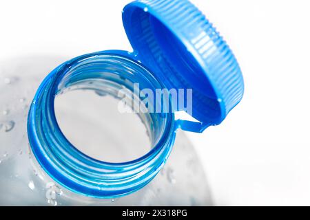 Close up of new cap attached to plastic bottle, connected to the neck of the bottle by solid tab attached to safety ring. They are intended to encoura Stock Photo