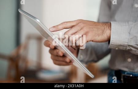 Hands, tablet and businessman in office for research with financial policy review for inflation. Scroll, professional and finance advisor working on Stock Photo