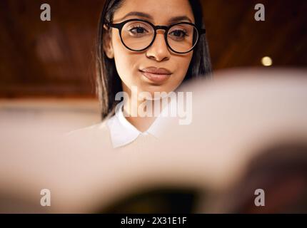 College student, face and girl reading book in home for university, research and school education. Learning, knowledge and Indian woman with Stock Photo