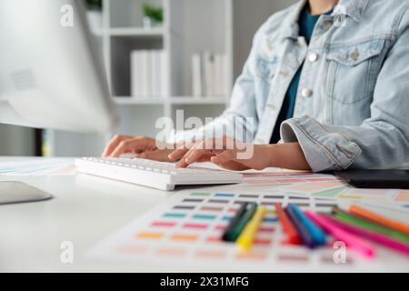 Graphic UI designer work on computer laptop and with graphic, working after brainstorming unique design with professional developer UX team Stock Photo