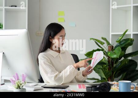 Graphic or UI designer work on computer laptop after brainstorming unique design with professional developer UX team Stock Photo