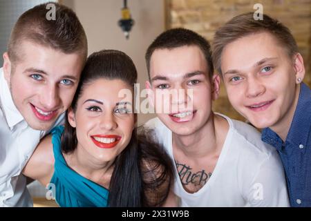 Portrait of three smiling guys musician and a girl singer closeup Stock Photo