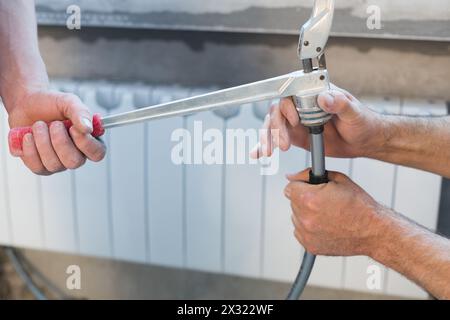 Preparation the pipes for the heating system crimping Stock Photo