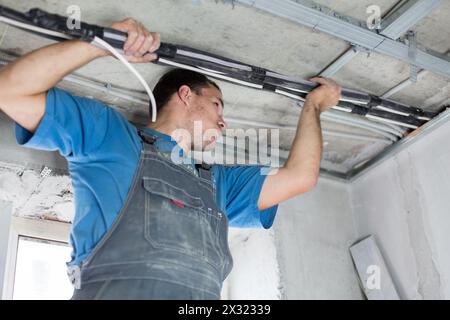 A worker set the tube on the ceiling for air conditioner Stock Photo