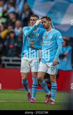 Phil Foden of Manchester City celebrates with Bernardo Silva of Manchester City scorer of Manchester City’s winning goal - Manchester City v Chelsea, The Emirates FA Cup Semi Final, Wembley Stadium, London, UK - 20th April 2024 Stock Photo