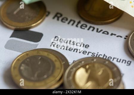 Berlin, Germany. 24th Apr, 2024. Coins lie on a pension information sheet from the German Pension Insurance. Credit: Fernando Gutierrez-Juarez/dpa/Alamy Live News Stock Photo