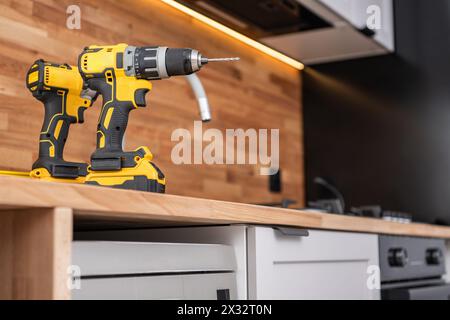 Home Kitchen Remodeling Theme. Two Drill Drivers Power Tools on the Kitchen Counter Top. Stock Photo