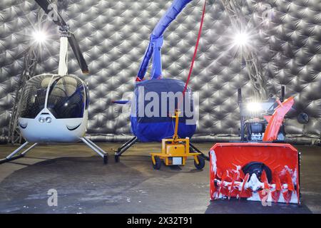 MOSCOW, RUSSIA - DEC 21, 2013: Two private helicopters in hangar of Heliport Moscow - unique project to create Europe largest helicopter multi-center Stock Photo