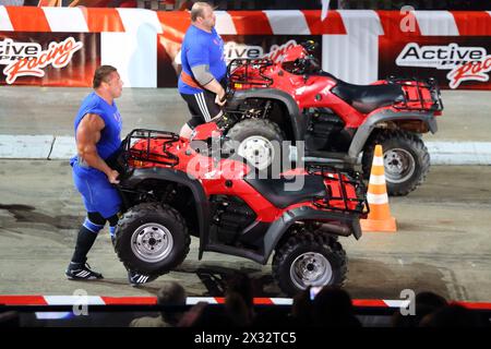 MOSCOW - MAR 02: Strong men raise ATVs on the festival extreme sports Breakthrough 2013 in the arena of the Olympic Sports Complex, on March 02, 2013 Stock Photo