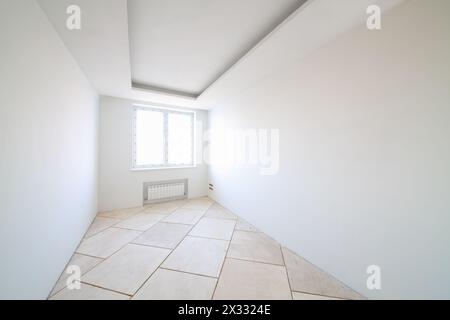 Room with white walls and window in new apartment without finishing Stock Photo