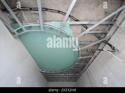 Split-level ceiling metal frame for plasterboard in an arc shape Stock Photo