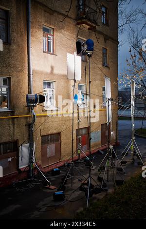 Professional lighting equipment - floodlights, reflecting screens - mounted near old house wall Stock Photo