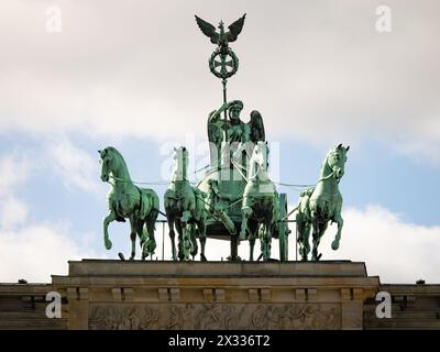 Quadriga sculpture group on the Brandenburger Tor building exterior in Berlin, Germany. The bronze art piece is made by Johann Gottfried Schadow. Stock Photo