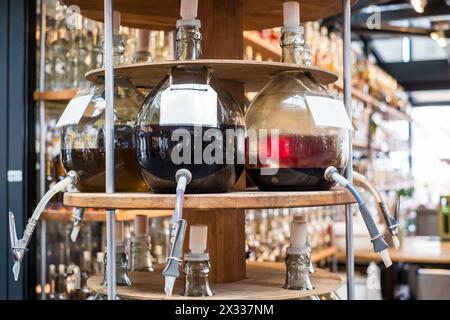 Olive oils and balsamic vinegars in large glass containers with a tap. Stock Photo