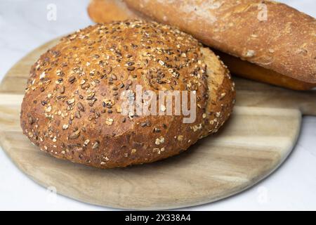 Freshly baked bread on a cutting board. Stock Photo