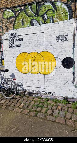 Copenhagen, Denmark - 06 Apr 2024: Dance and movement themed wall art drawing in Freetown Christiania building. Stock Photo