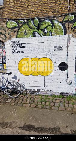 Copenhagen, Denmark - 06 Apr 2024: Dance and movement themed wall art drawing in Freetown Christiania building. Stock Photo