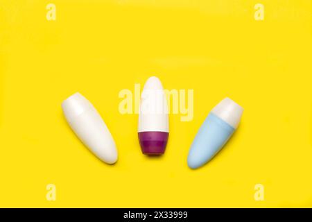 Three blank plastic bottles on a yellow background with copy space Stock Photo