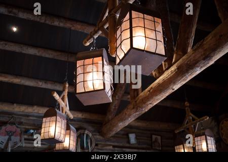 Old lantern are hanging under the ceiling with beam. Stock Photo