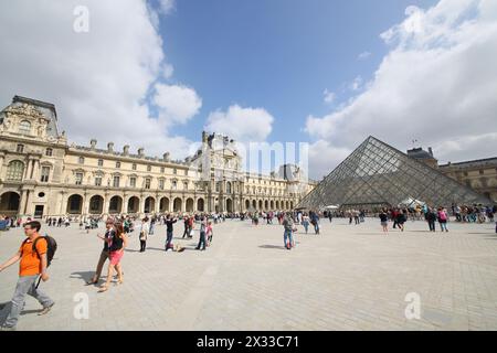 PARIS, FRANCE - SEP 11, 2014: Area with lots of tourists near the main entrance to the Louvre Stock Photo