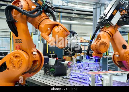 Augsburg, Bavaria, Germany - April 24, 2024: Kuka industrial robots on display in the AI research hall  Hall 43  of the University of Augsburg *** Kuka Industrieroboter ausgestellt in der KI-Forschungshalle Halle 43 der Universität Augsburg Stock Photo