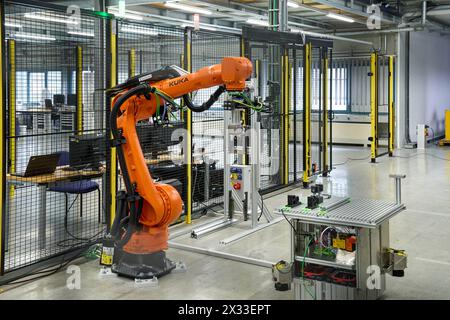 Augsburg, Bavaria, Germany - April 24, 2024: Kuka industrial robots on display in the AI research hall  Hall 43  of the University of Augsburg *** Kuka Industrieroboter ausgestellt in der KI-Forschungshalle Halle 43 der Universität Augsburg Stock Photo