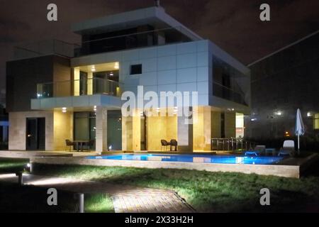 SOCHI, RUSSIA - JUL 27, 2014: Area of the Hotel Radisson Blu Paradise Resort and Spa near the outdoor pool in the evening Stock Photo