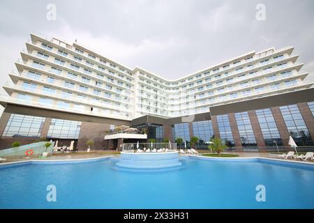 SOCHI, RUSSIA - JUL 27, 2014: Building of the Hotel Radisson Blu Paradise Resort and Spa near the pool Stock Photo