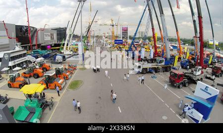 RUSSIA, MOSCOW - JUN 6, 2014: People walk near machines on International Specialized Exhibition of Construction Equipment and Technologies CET 2014 at Stock Photo