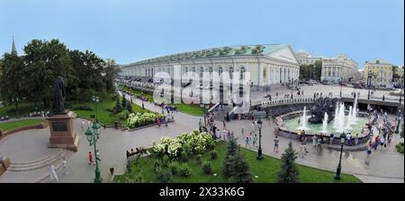 MOSCOW - AUG 12, 2014: Building of the Central Exhibition Hall on Manezh Square and Monument to Patriarch Hermogenes in the Alexander Garden, aerial v Stock Photo