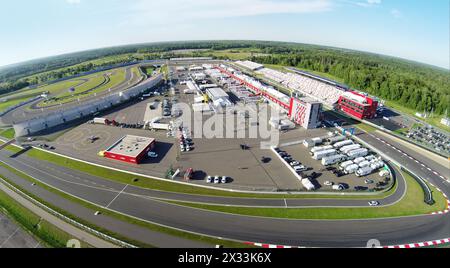 RUSSIA, MOSCOW - JUL 12, 2014: Trucks and cars parked on stadium Moscow Raceway. Aerial view (Photo with noise from action camera) Stock Photo