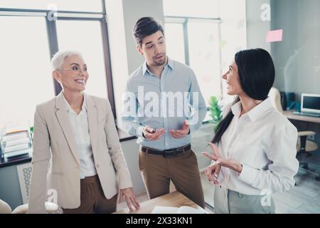 Photo of two employees mature boss woman talking office team meeting discussion colleagues working together in workstation Stock Photo