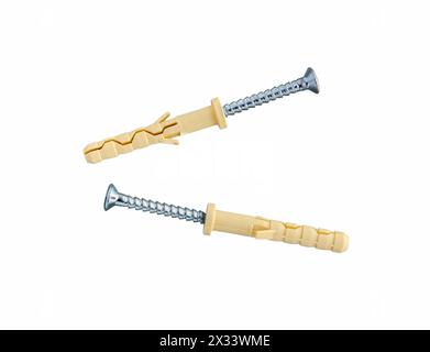 Screws and plastic dowels on white background. Stock Photo