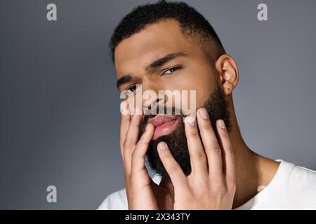 A close-up of a man with a beard taking care of his skin. Stock Photo