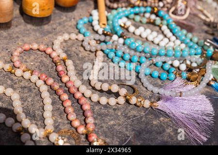 A variety of rosary with gemstone beads lies on the counter of a street market in Bukhara Stock Photo