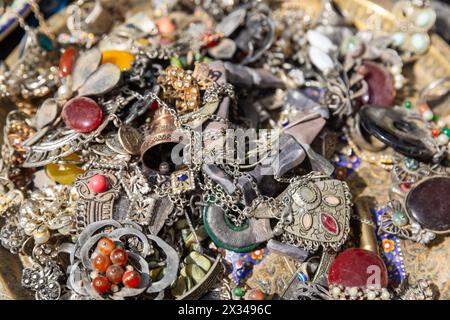 A variety of jewelry lies on the counter of a street market in Bukhara Stock Photo