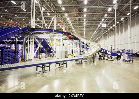 RUSSIA, MOSCOW - DEC 16, 2014: Employees working in the large post department of automated sorting center in Vnukovo. Moscow Automated sorting center Stock Photo