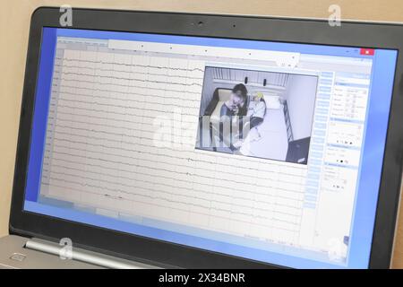 Сomputer monitor with software and video images on camera, which monitors patient. Two people on image Stock Photo