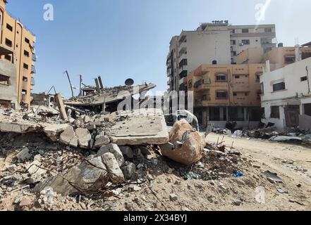 Palestinians walk past the rubble of residential buildings destroyed by Israeli strikes Palestinians walk past the rubble of residential buildings destroyed by Israeli strikes, amid the ongoing Israel war on gaza, in the Gaza City, April 24, 2024. Photo by Khaled Daoud  apaimages Gaza city Gaza Strip Palestinian Territory 240424 Gaza KHD 0018 Copyright: xapaimagesxKhaledxDaoudxxapaimagesx Stock Photo