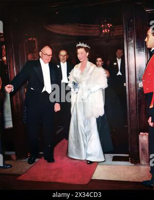 Queen Elizabeth II is shown attending the Royal Film Performance at the Empire, Leicester Square, in October 1952. This event features major film premieres attended by members of the Royal Family. The 1952 showcase was the musical comedy 'Because You're Mine,' starring Mario Lanza. Stock Photo