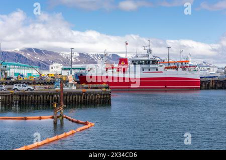 Reykjavik, Iceland, 14.05.22. Fishing vessel Stormur GR 6-44 docked at Old Harbor in Reykjavik, with snowcapped mountains and port infrastructure. Stock Photo