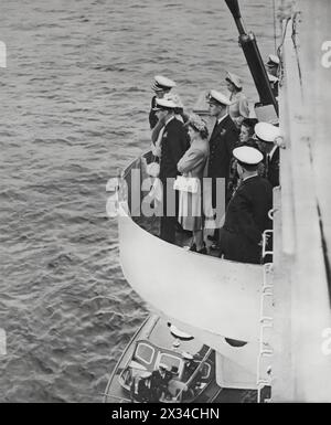 Princess Elizabeth and Philip, the Duke of Edinburgh, are pictured accompanying King George VI on board H.M.S Maidstone, shortly after their engagement in 1947. This image captures a new era in the British monarchy, with Elizabeth and Philip welcoming Prince Charles into the world soon after, and Elizabeth's acension to the throne in 1952. Stock Photo